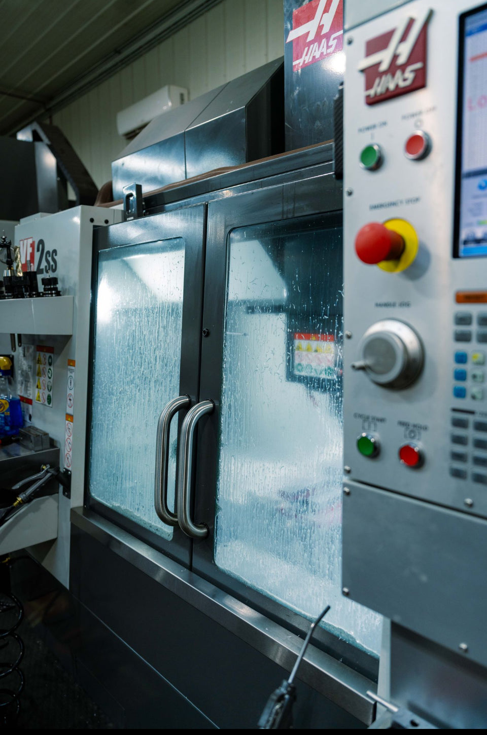 Industrial machine with control panel and display in a workshop setting