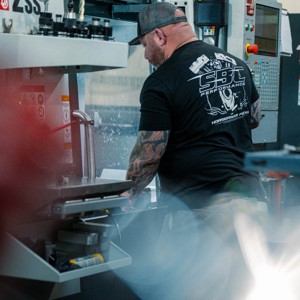 Person working on a machine in a workshop setting